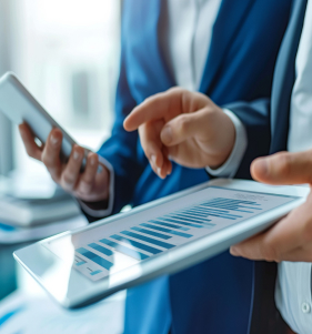 Executives reviewing data on a tablet and phone device